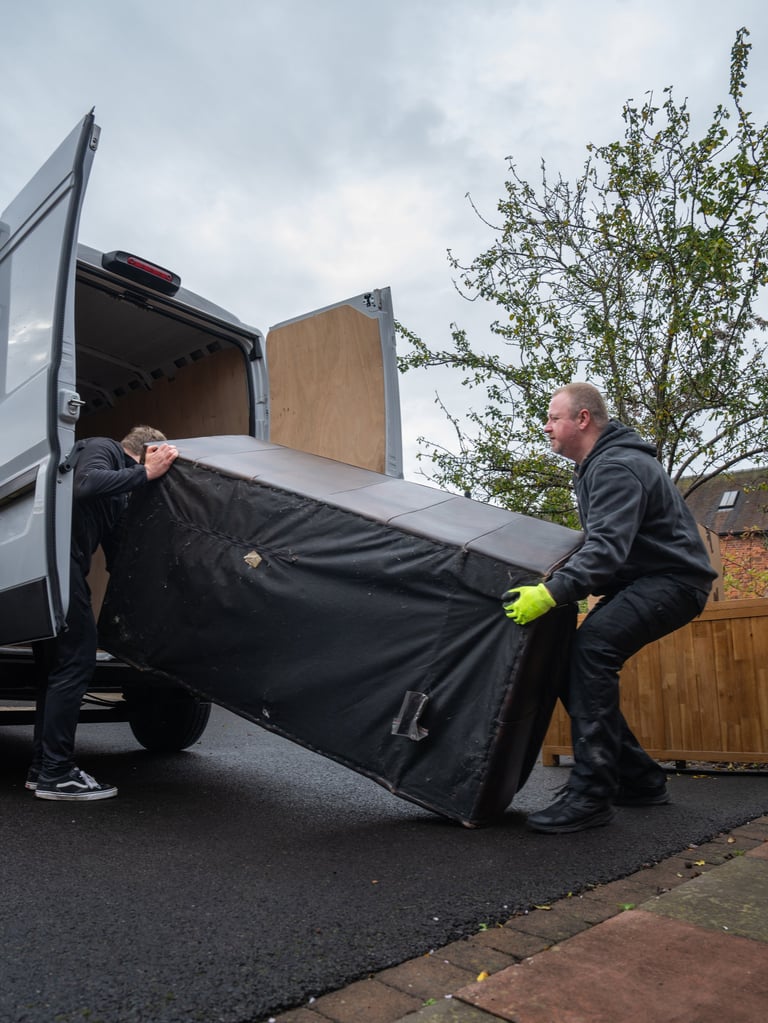 Professional junk removal team loading items into truck